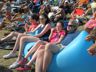 Family relaxing in an inflatable lounger, Folk Festival 2016