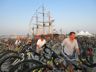 Departing the festival by bike in the shadow of the Oliver Hazzard Perry schooner, Folk Festival 2016
