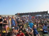 Crowd on the grass inside the fortress walls enjoying a performance on the Quad stage, Folk Festival 2019