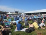 Crowd on the grass inside the fortress walls enjoying a performance on the Quad stage, Jazz Festival 2019